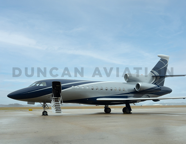 Exterior of freshly painted Falcon 900 by Duncan Aviation in shades of slate blue and light gray