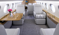 Light gray interior with light wood tones of Falcon 900