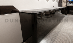 Close up view of dark wood credenza in refurbished Falcon 7X by Duncan Aviation