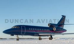 Newly painted Falcon 900 exterior in deep navy with magenta and light blue stripe