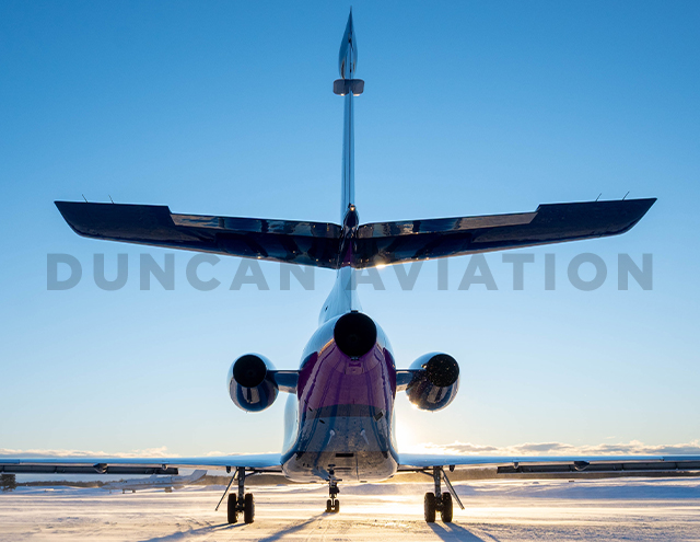 Refurbished paint by Duncan Aviation on Falcon 900 in dark blue, magenta, and light blue