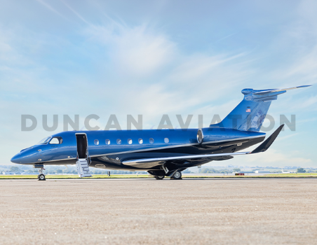 Exterior of a newly painted Embraer EMB500 in bright blue and navy