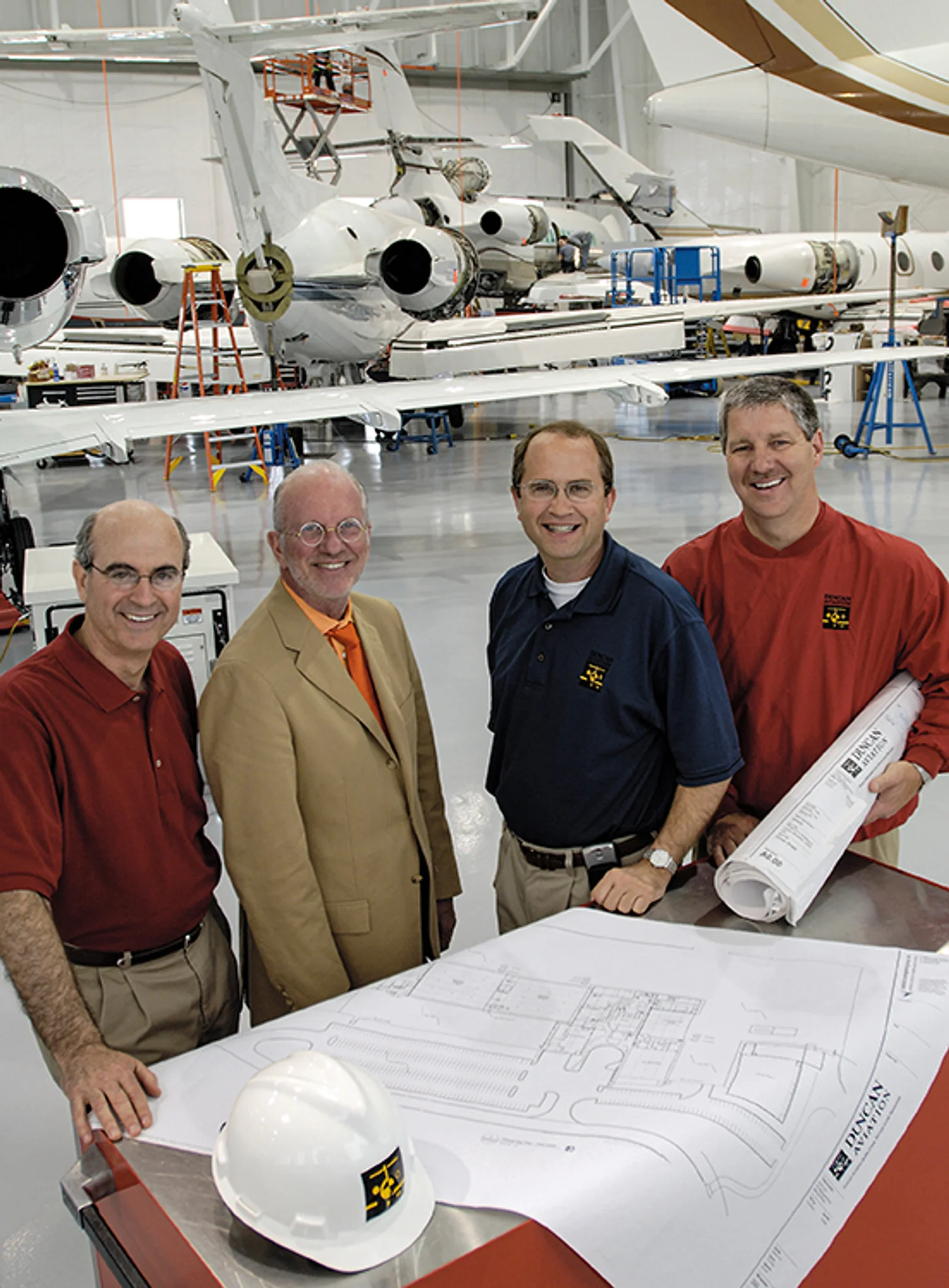 Tom Burt, Robert Duncan, Aaron Hilkemann, and Bill Prochazka with Battle Creek&rsquo;s expansion blueprints in 2006.