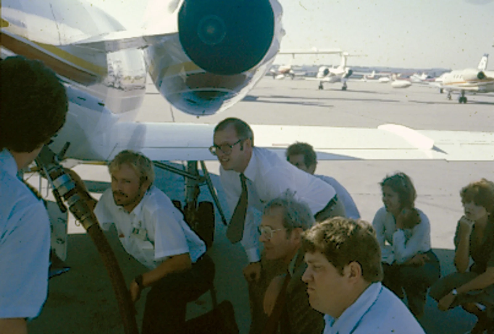 Craig Nordbrock, Robert Duncan, Bernard Michael, Bob Tooker, Kent Kussatz, Pam Orr, and Jean Warner receive aircraft fueling training in 1981.